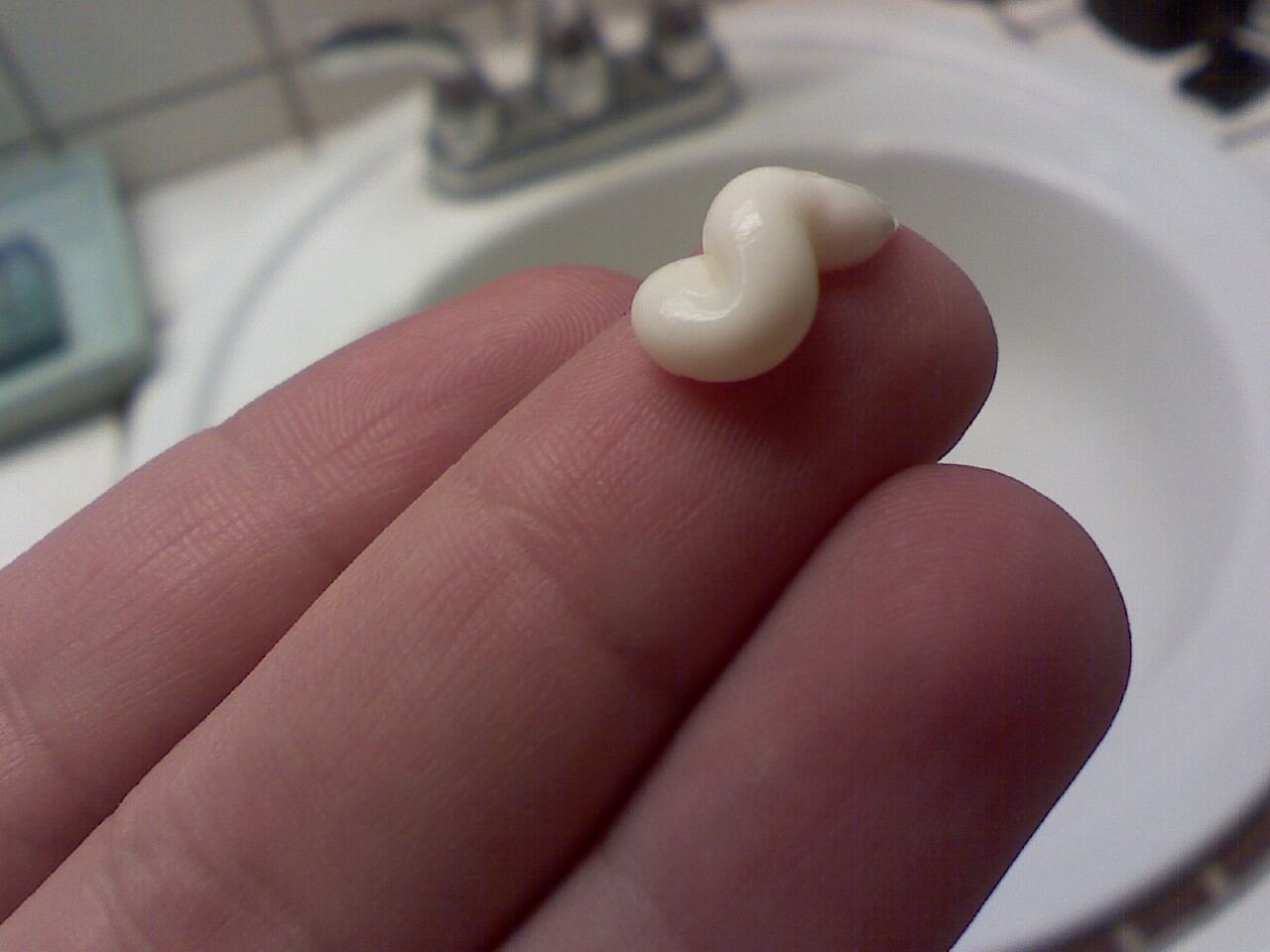 A small amount of moisturizer on a fingertip
